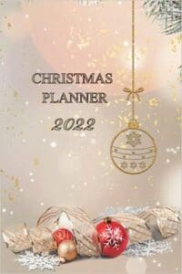 A christmas planner cover with a red bird and gold ornaments.