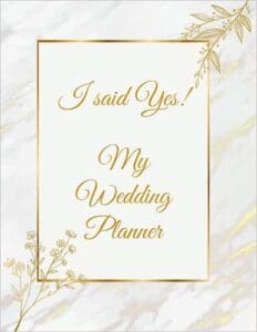 A wedding planner book with gold foil accents.