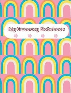 A pink notebook with rainbow pattern on it.