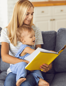 A woman and baby are reading a book.