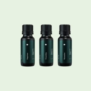 Three bottles of green liquid on a light green background