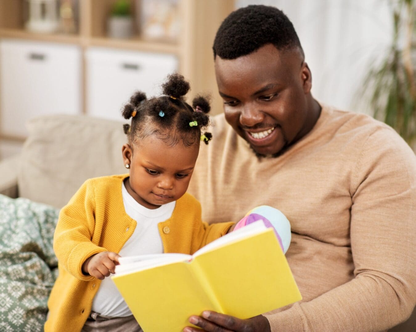 A children's book author and her daughter reading on the couch, bringing a fresh perspective to their storytelling.